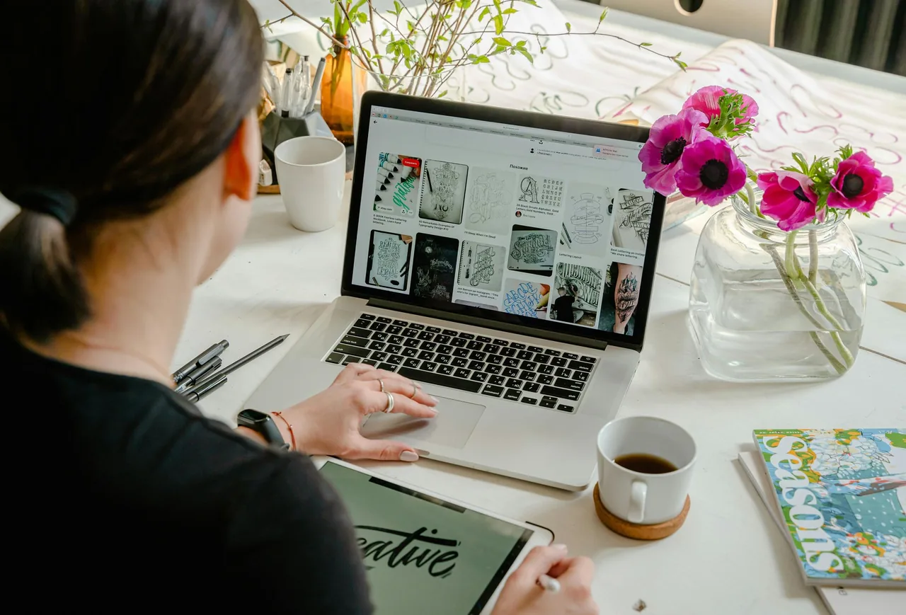 Person reviewing website layouts on a laptop.