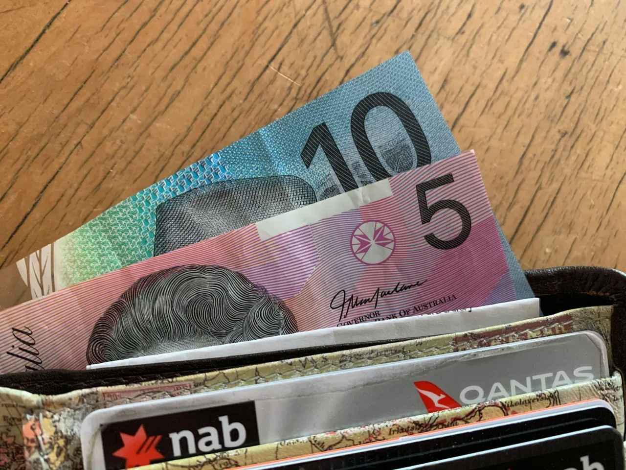 Australian banknotes and payment cards in a wallet.
